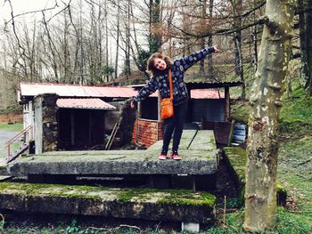 Bare trees growing on wooden wall