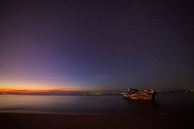 Scenic view of sea against sky at night