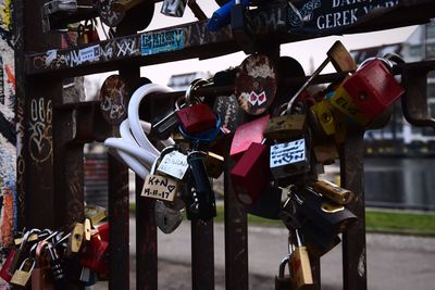 Close-up of padlocks hanging on railing