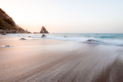 Scenic view of beach against clear sky