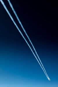 Low angle view of vapor trail