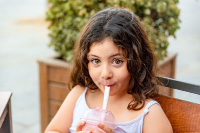Portrait of girl drinking milkshake