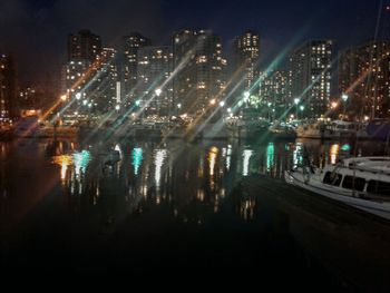Illuminated city against sky at night