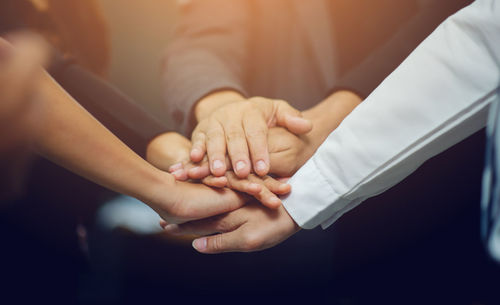 Midsection of couple holding hands