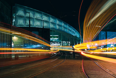 Illuminated light trails on road at night