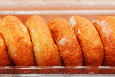 Baked sweet donuts with powdered sugar . donuts for sale