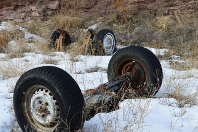 Abandoned wheels on snowy field