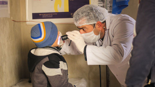 Close-up of doctor examining boy