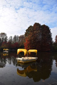 Boat moored in lake against sky