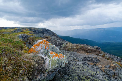 Scenic view of rock on landscape against sky