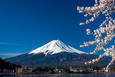 Scenic view of snowcapped mountains against clear blue sky