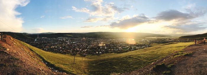 Panoramic view of city against sky during sunset