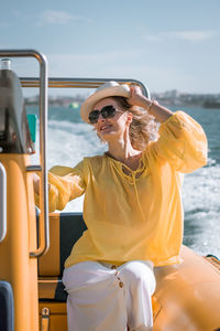 Young woman sitting in boat on sea