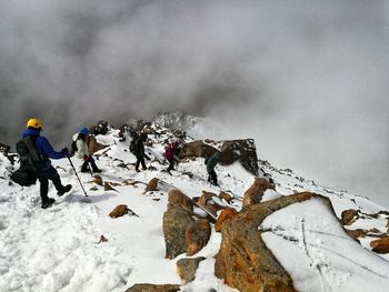 View of people on snow covered mountain