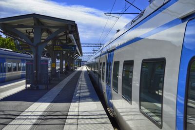 Train at railroad station against sky