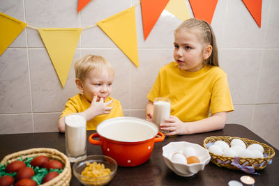 Kids prepare dough for holiday cupcake holiday easter, eggs on the table