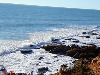 Scenic view of beach against sky during winter