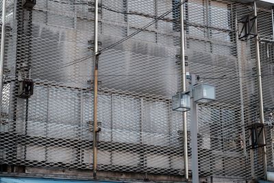 Full frame shot of chainlink fence against building