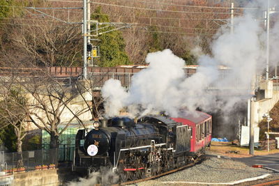 Smoke emitting from train on railroad track