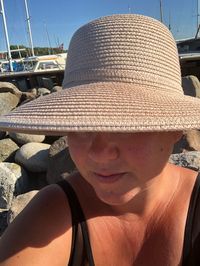 Close-up portrait of young woman wearing hat