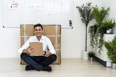Portrait of young man sitting on seat