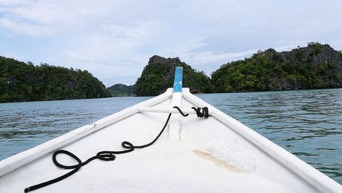 Close-up of boat in sea against sky