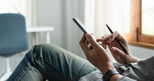 Midsection of woman using mobile phone