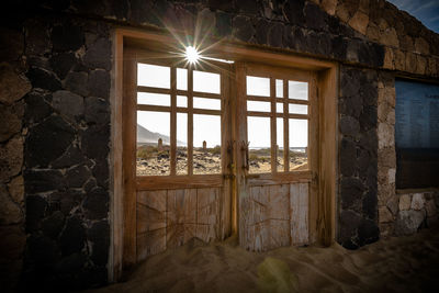 Sunlight streaming through window of abandoned house