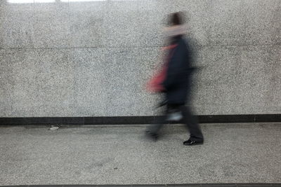 Blurred motion of man walking in basement