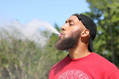 Bearded man smoking outdoors
