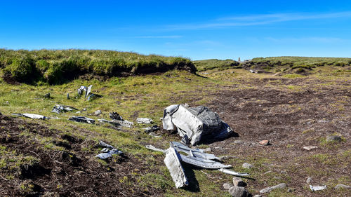 Scenic view of land on field against sky