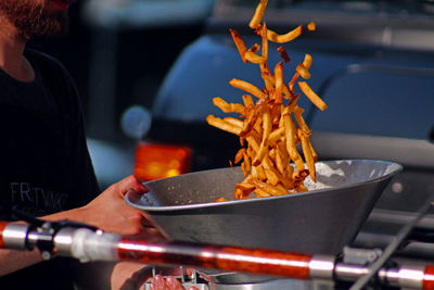 Midsection of man preparing french fries food