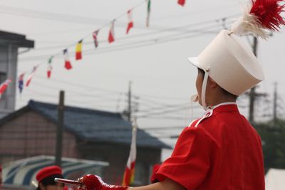 Close-up of boy in costume against sky