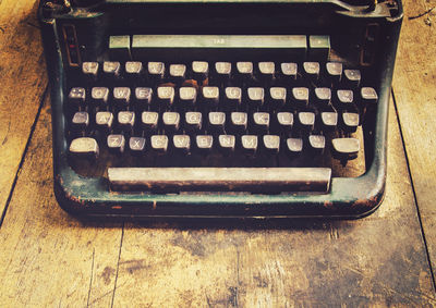 High angle view of vintage typewriter on wooden table