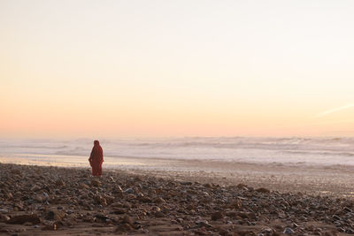 Scenic view of sea against orange sky