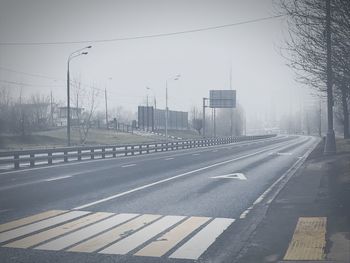 Road by city against sky