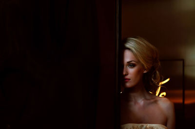 Beautiful woman in dress standing by door