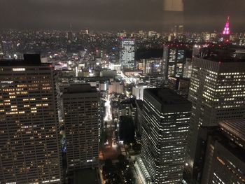 High angle view of illuminated buildings in city at night