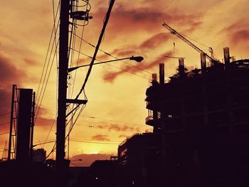 Low angle view of silhouette city against sky at sunset