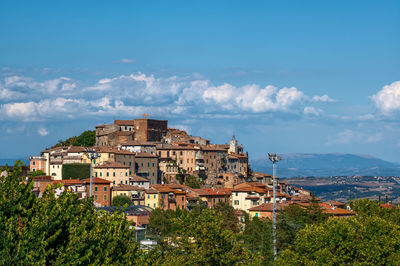 View of townscape by sea against sky