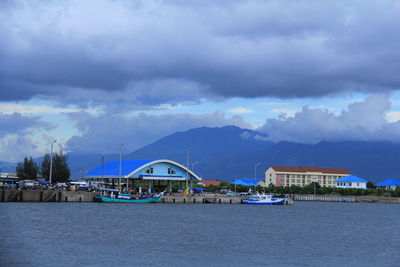 Scenic view of sea by buildings against sky
