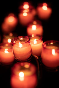 Close-up of lit tea light candles in temple