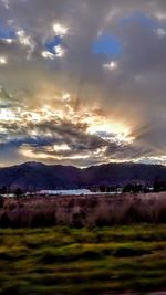 Scenic view of landscape against dramatic sky