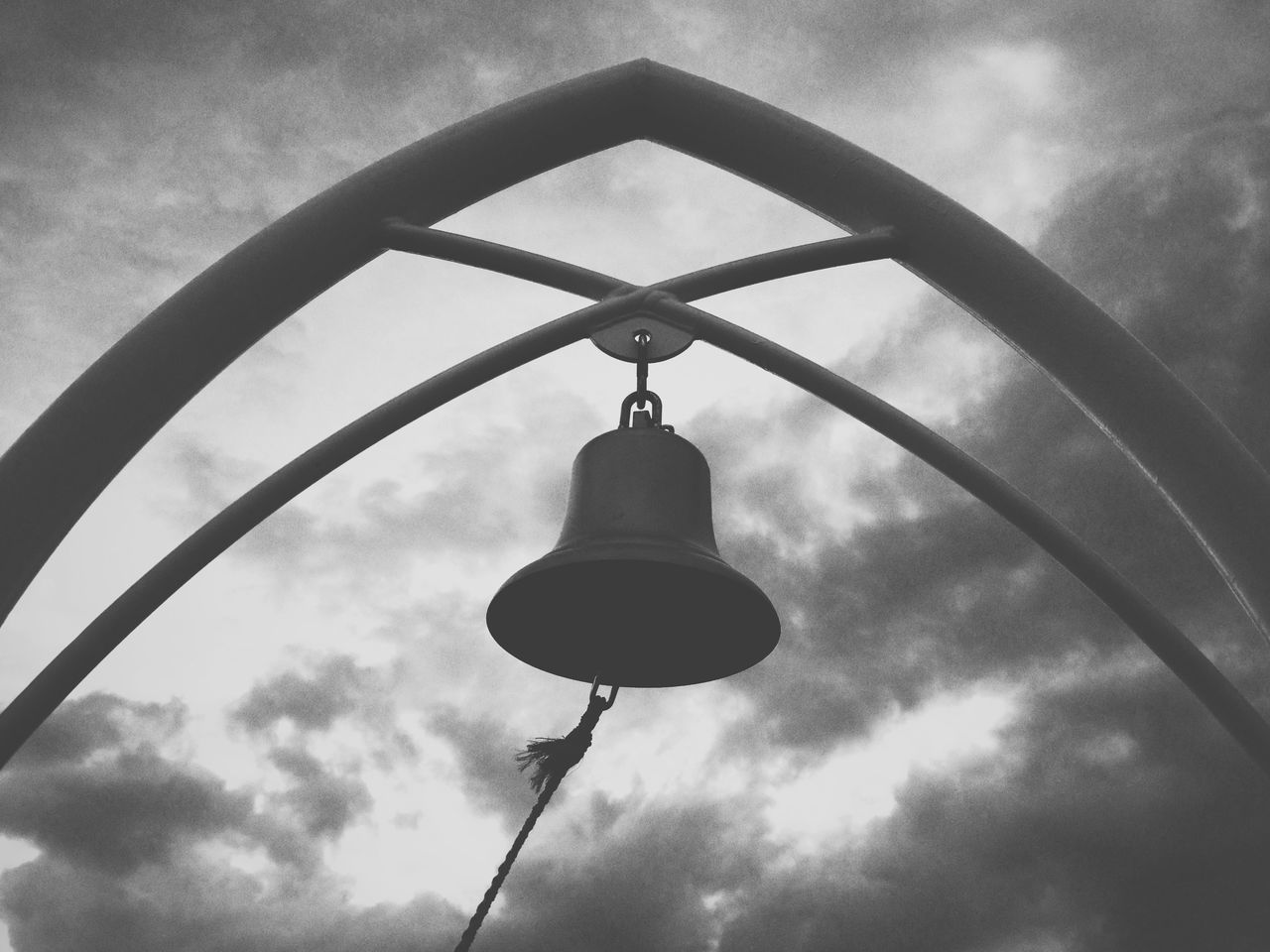 low angle view, sky, cloud - sky, lighting equipment, cloudy, street light, cloud, built structure, architecture, electricity, metal, hanging, day, connection, no people, technology, outdoors, cable, silhouette, power line