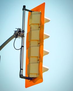 Low angle view of yellow tower against clear sky