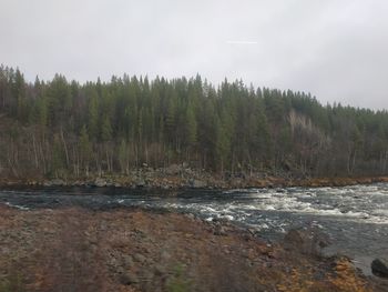 Scenic view of waterfall against sky