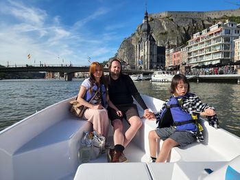 Portrait of woman , man and a boy, sitting in boat, family