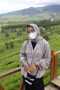 Rear view of woman standing on mountain