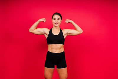 Portrait of young woman exercising in gym