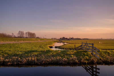 Scenic view of field against sky during sunset